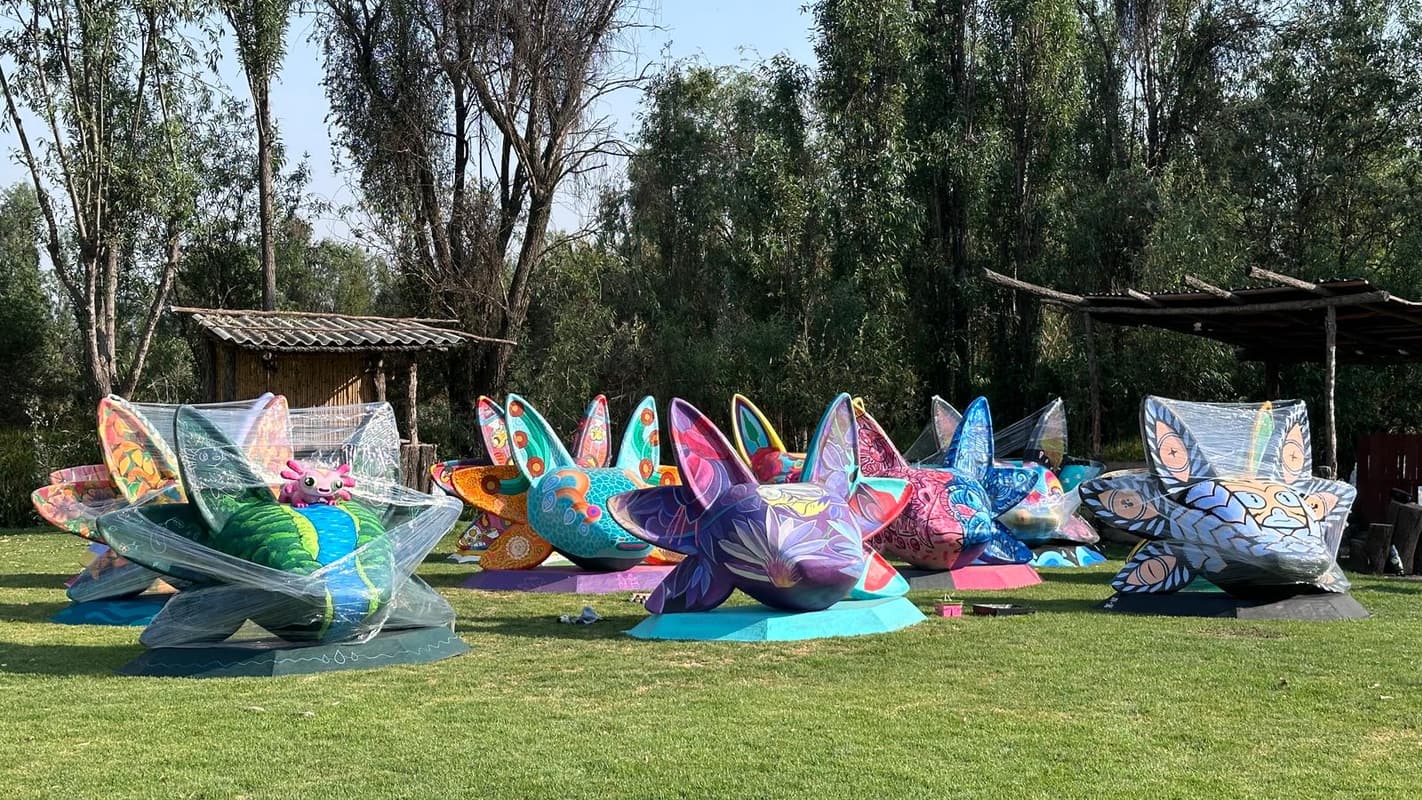 A row of painted sculptures along the field
