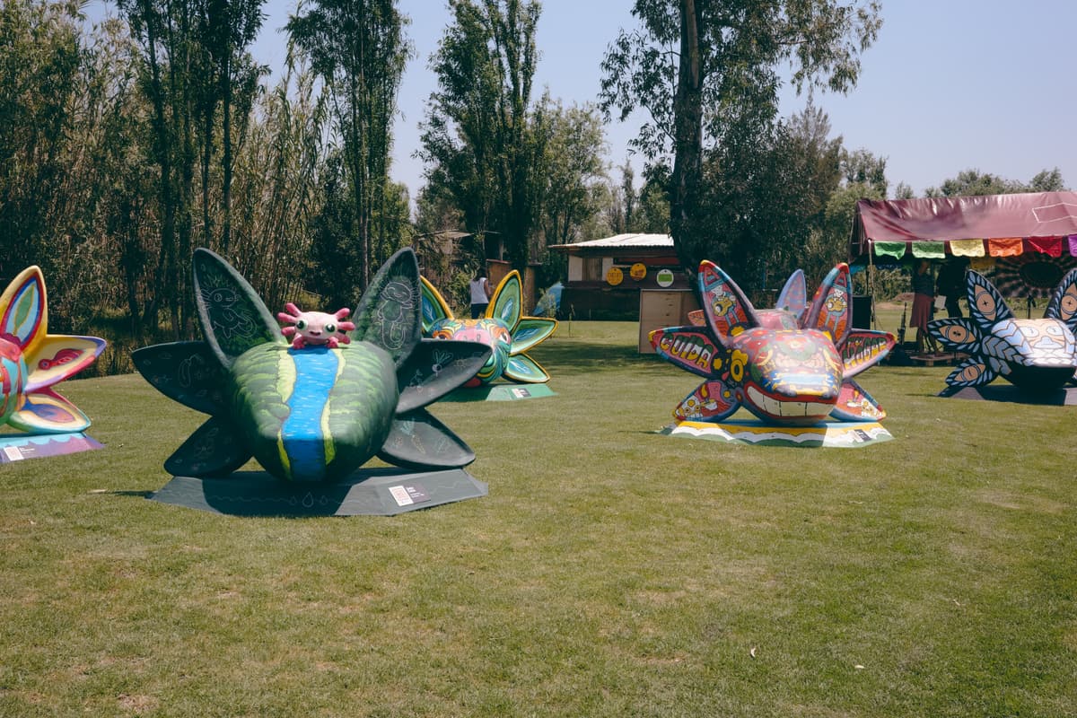 A row of painted axolotl sculptures across the expo lawn