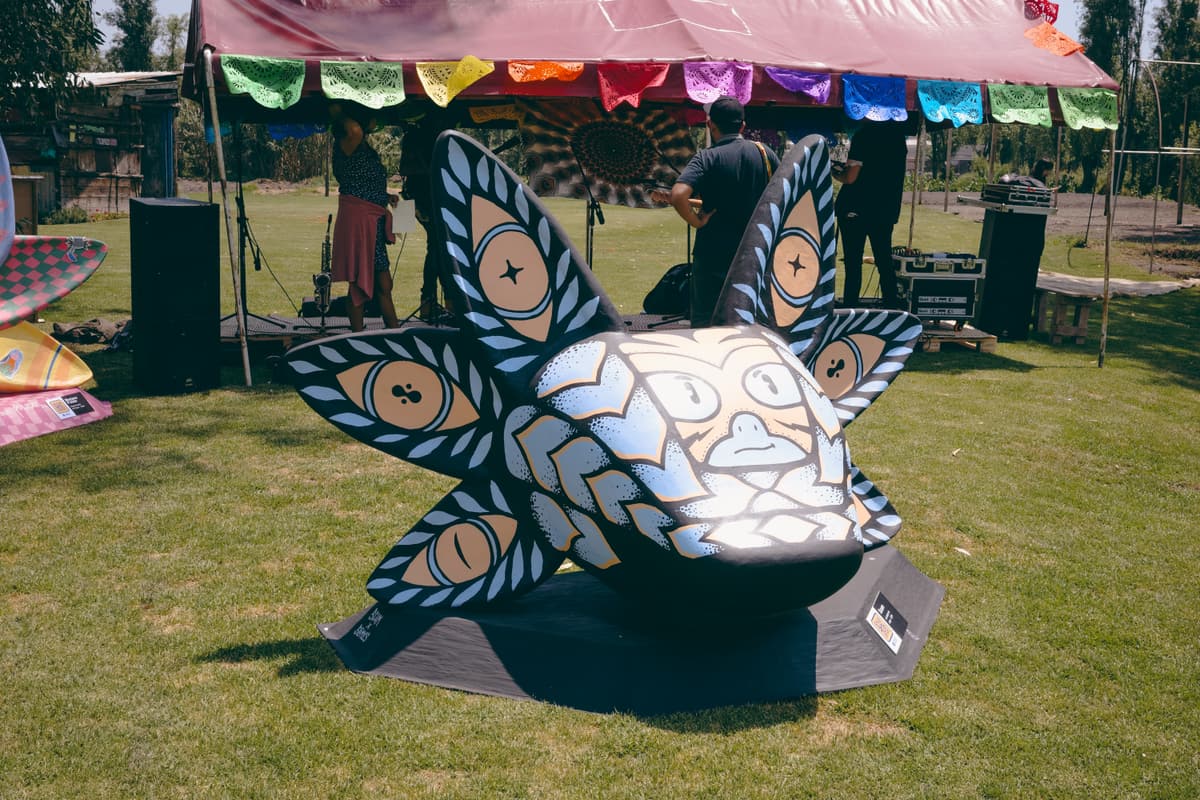 A black-and-white patterned sculpture beneath the stage canopy