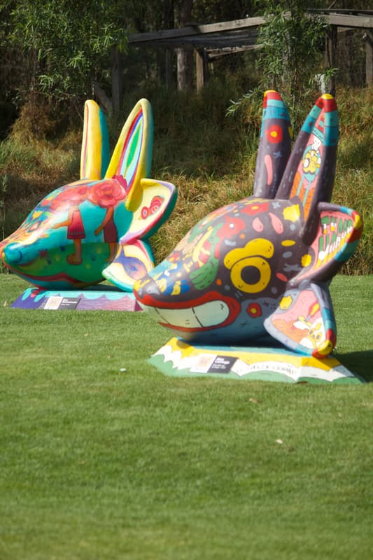 Two painted sculptures side by side on the lawn