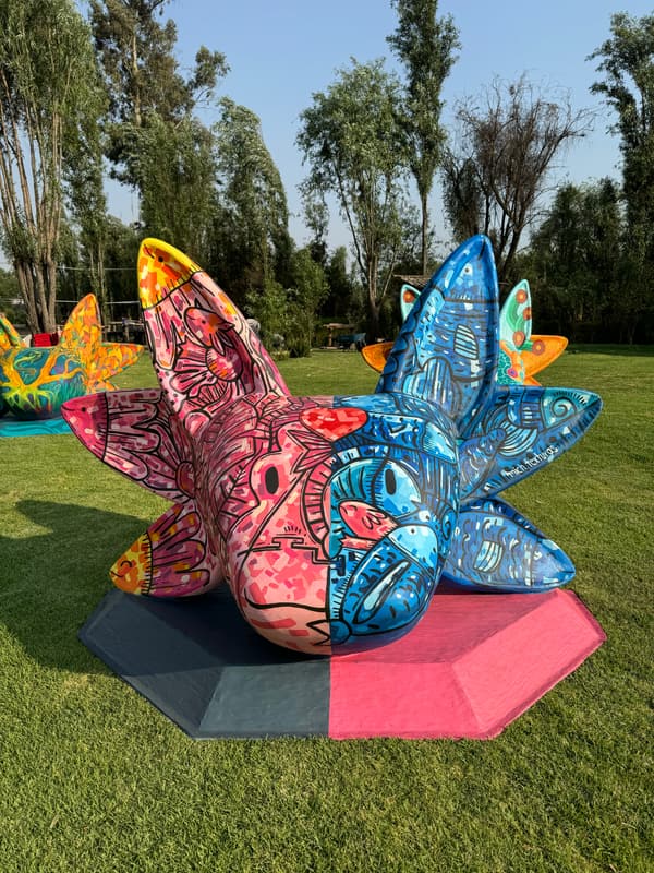A pink and blue sculpture covered in fine pattern