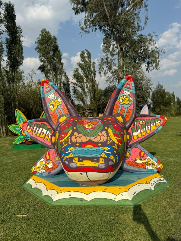 A sculpture lettered GUAPO across its fins