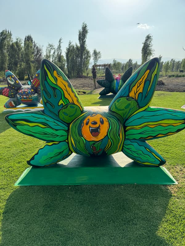 A green sculpture with an orange centre