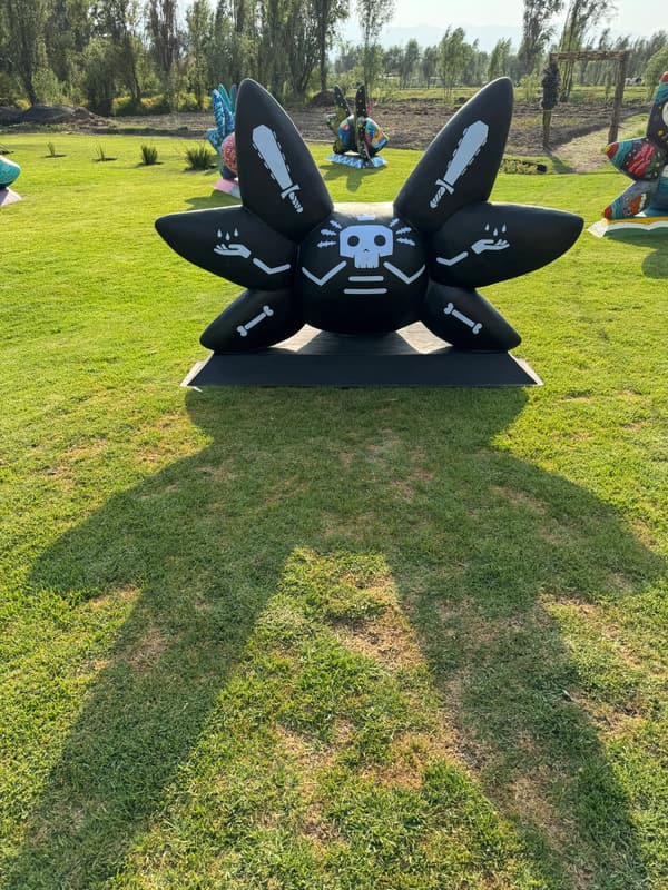 A black sculpture marked with skulls
