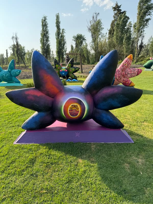 A deep purple sculpture ringed in orange