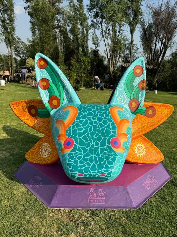 An orange and teal sculpture with a crackled pattern