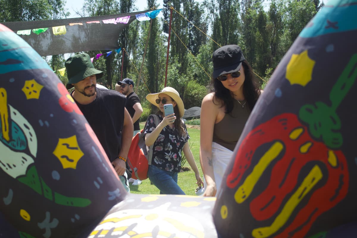 Guests standing between two painted sculptures