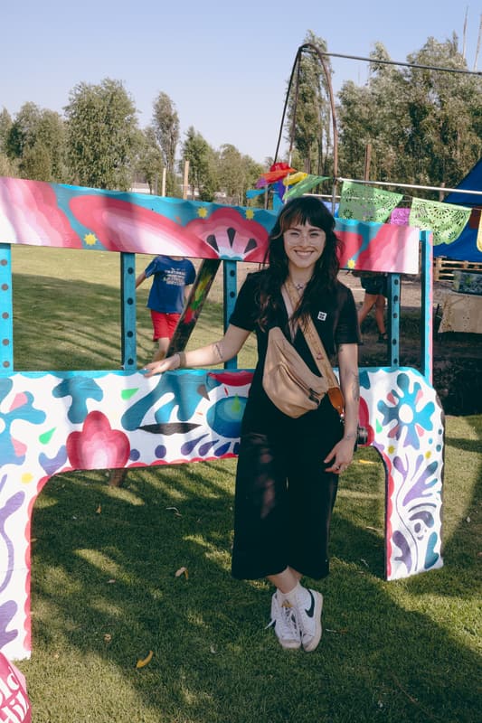 A visitor standing in front of a brightly painted archway