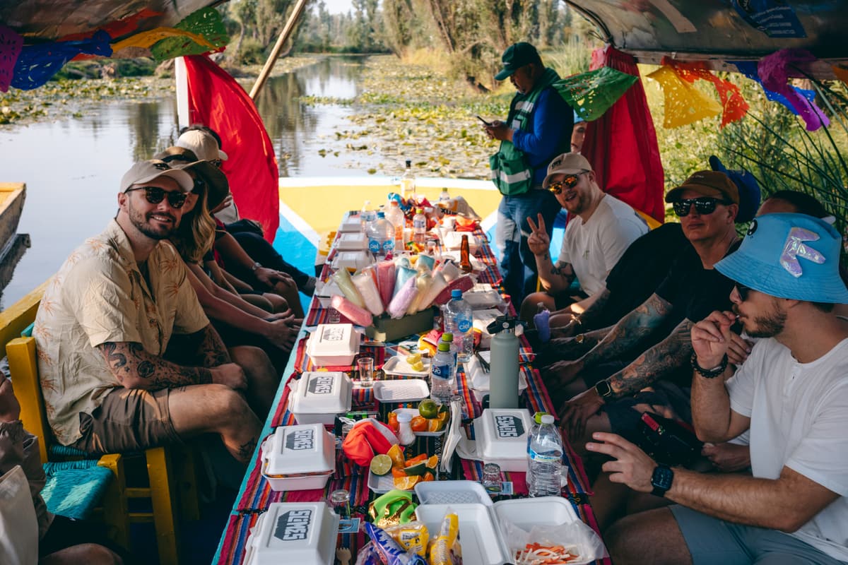 A long table of guests sharing a meal aboard the boats