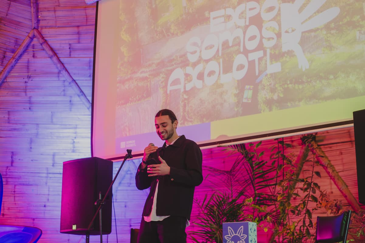 A speaker introducing the expo beneath the projected title