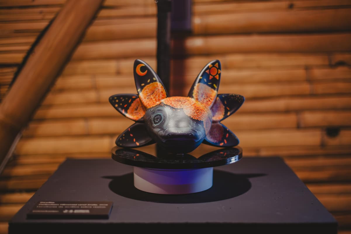 A patterned axolotl sculpture on its plinth