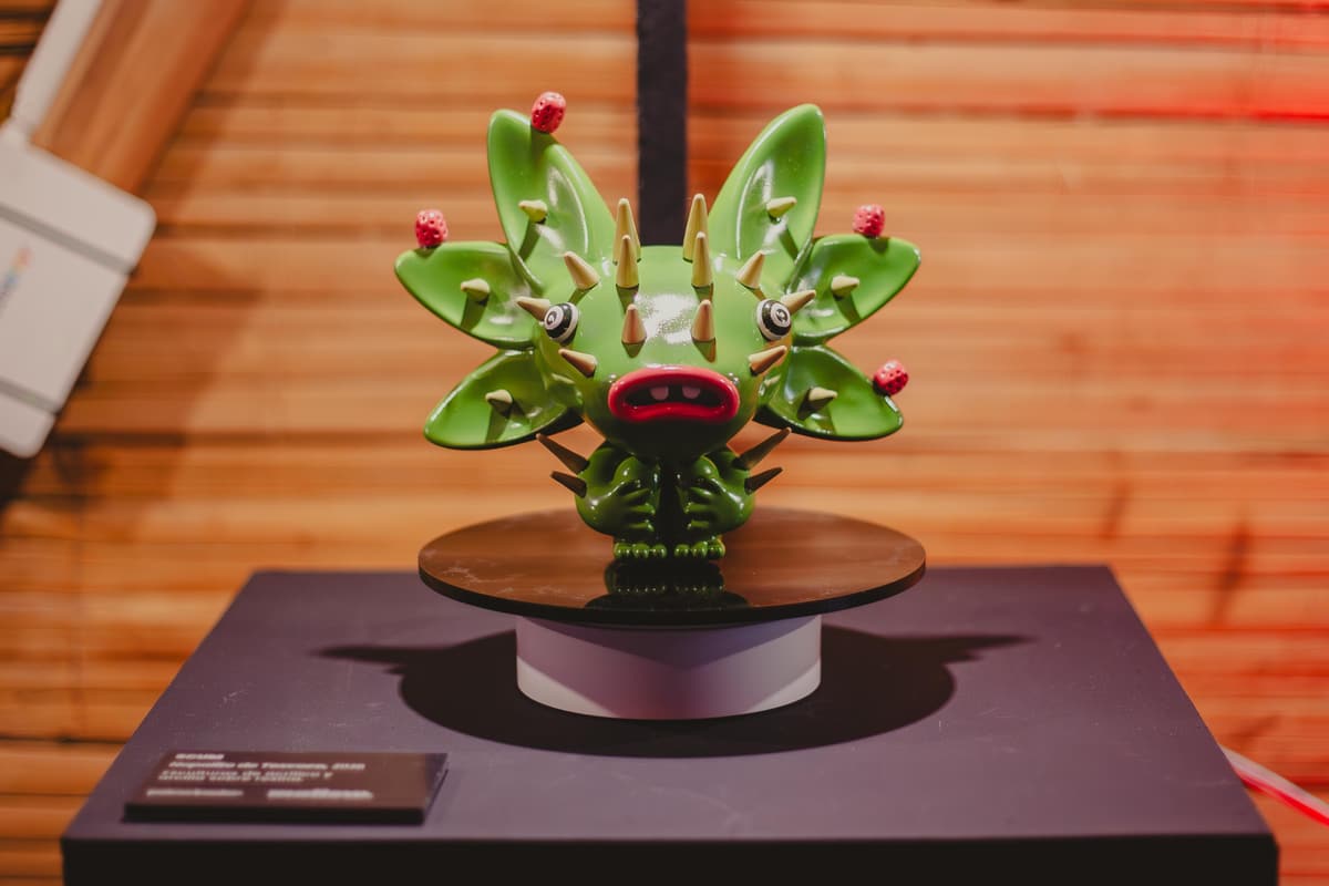 A green sculpture with budding fins