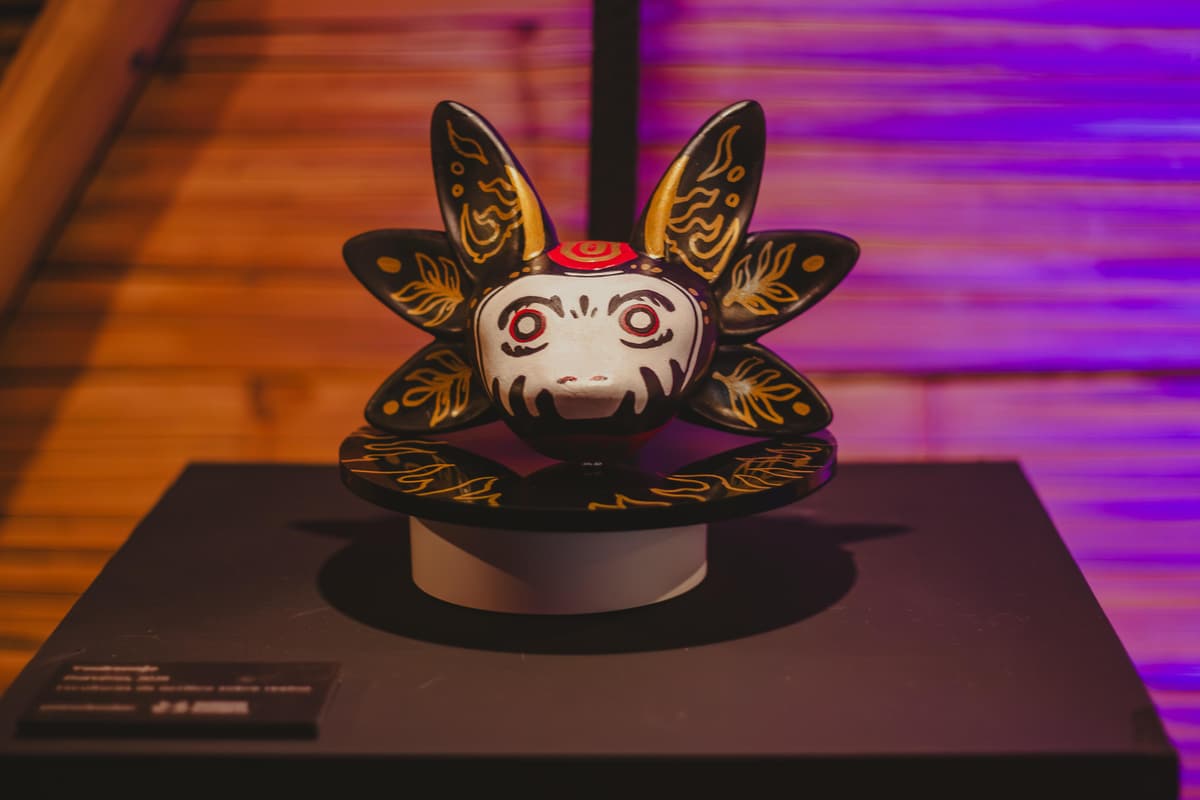 A sculpture with a pale skull-like face