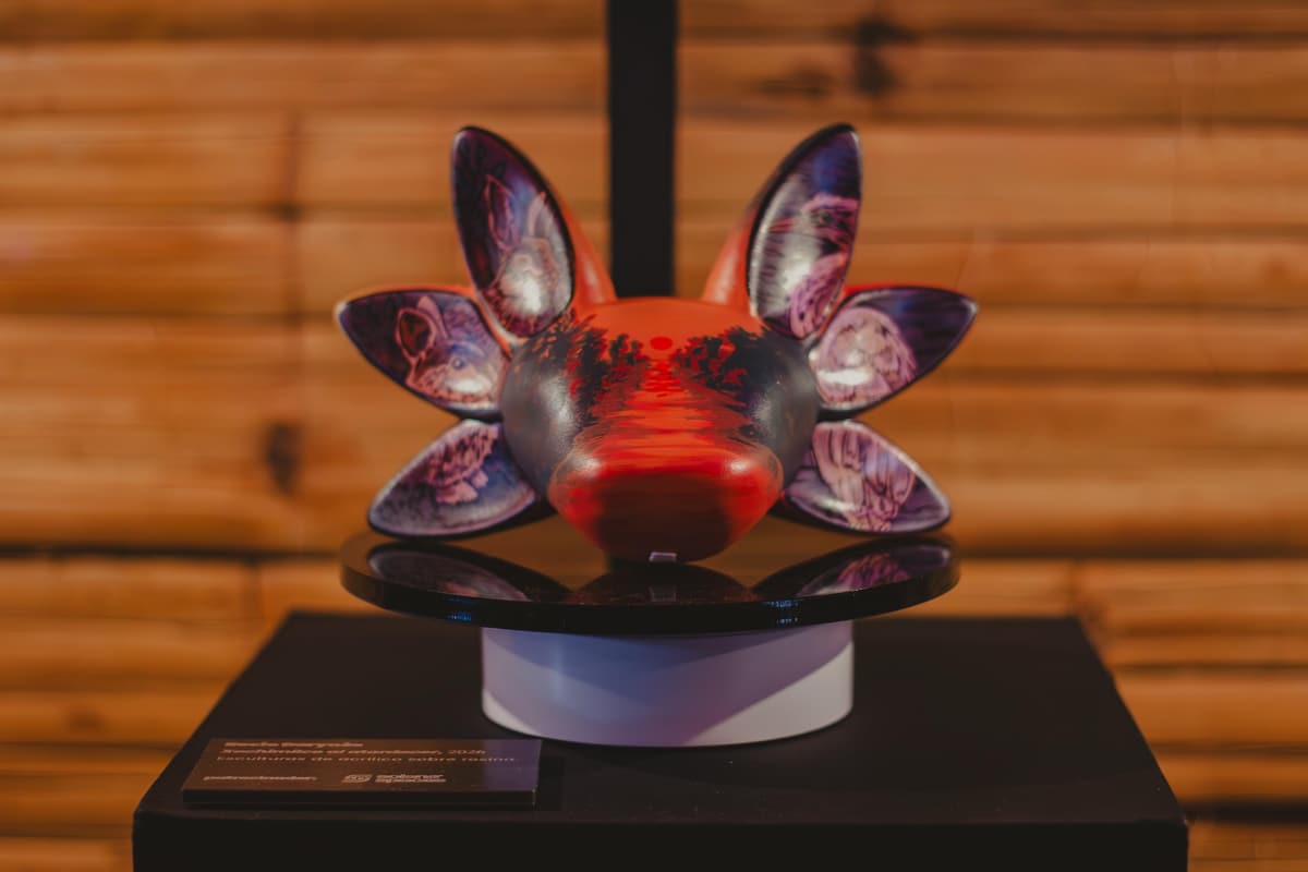 A deep red sculpture on its plinth