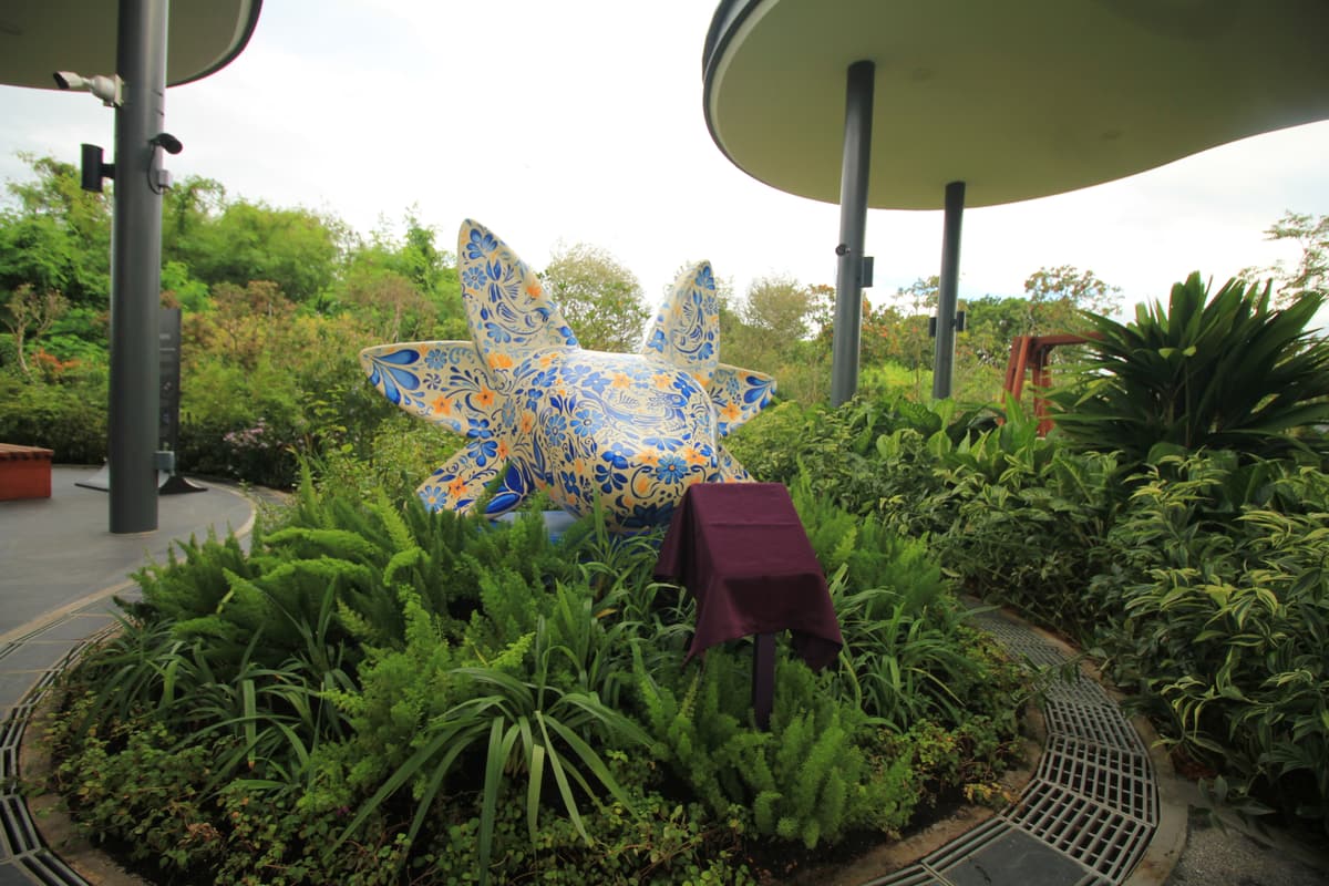 The sculpture in its planting bed beneath the garden's canopy