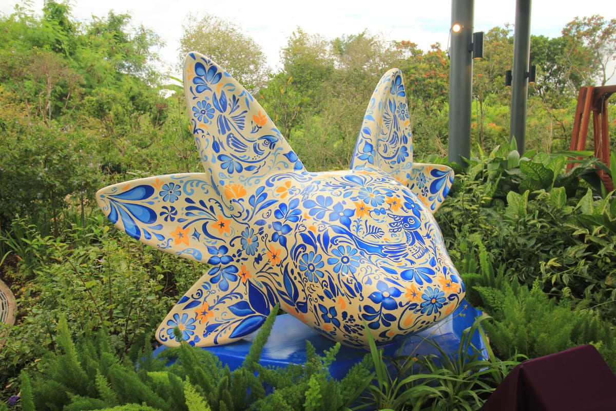 A closer view of the sculpture's painted fins and flowers