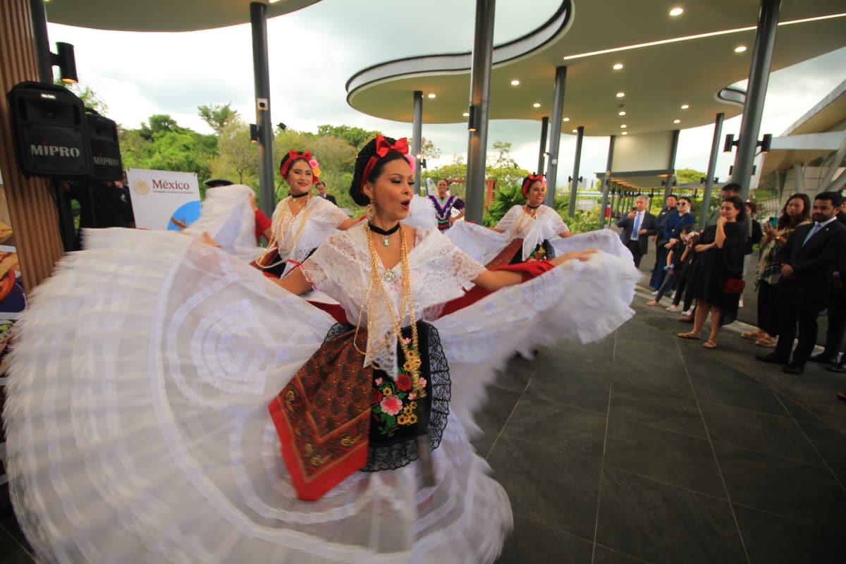 A folklorico dancer spinning in a white dress