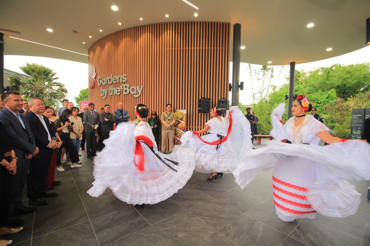 Two dancers mid-performance in white dresses