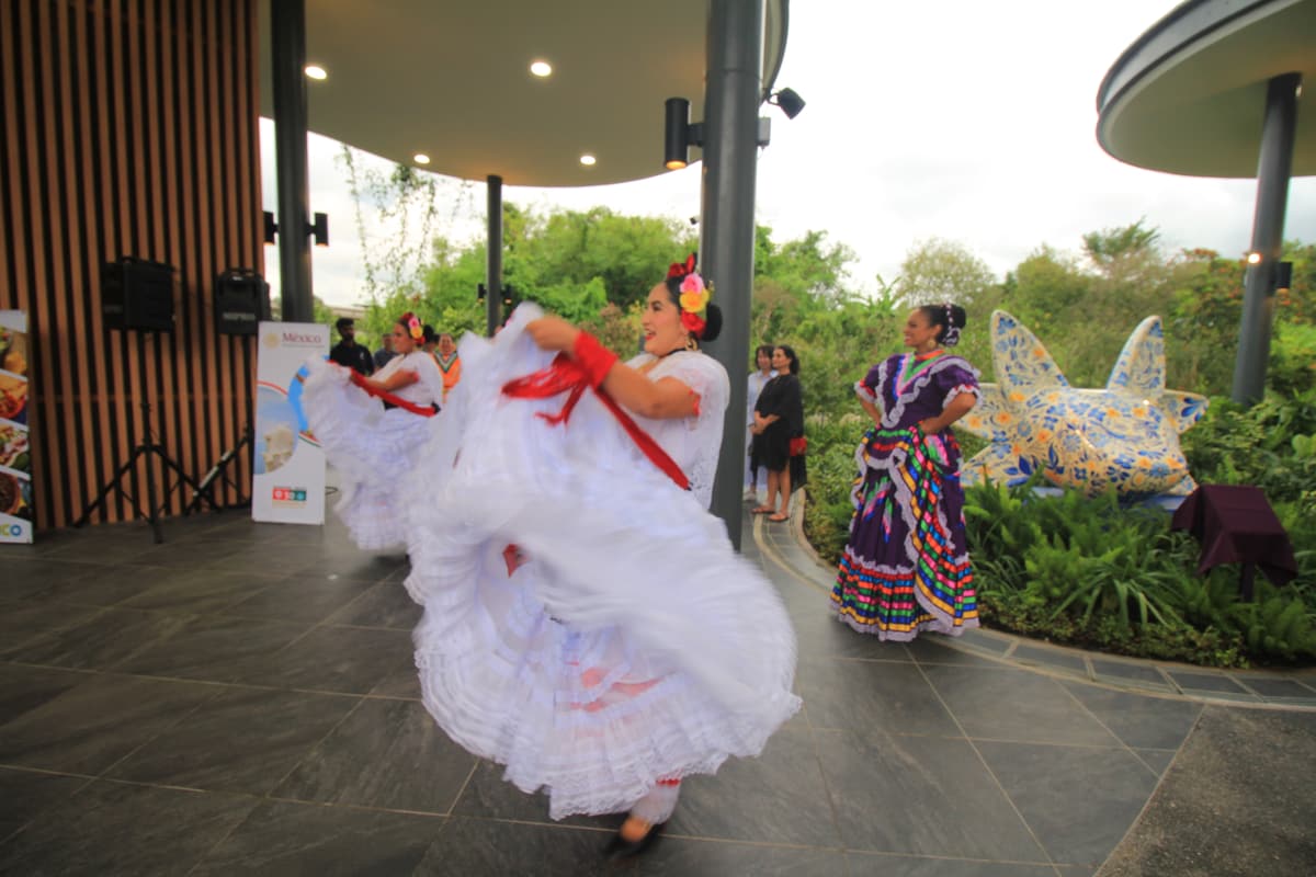 A dancer turning in front of the sculpture