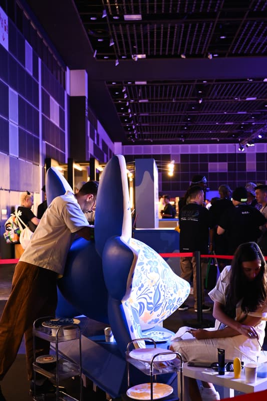 The team at work at a table beside the sculpture in the hall