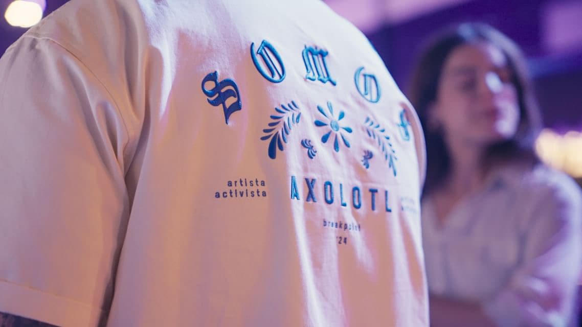 The embroidered Somos Axolotl shirt up close